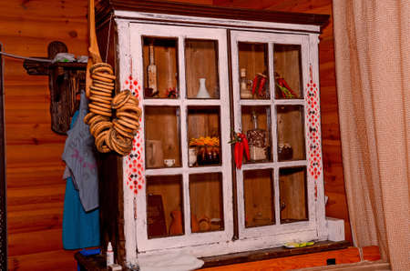 on the wall is a wardrobe in which a lot of Ukrainian dishesの写真素材