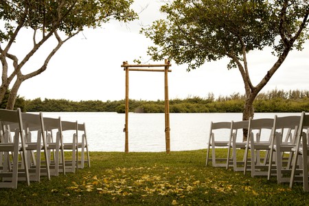 Tranquil wedding setting with trellis, water and trees Tranquil wedding setting with trellis, water and trees