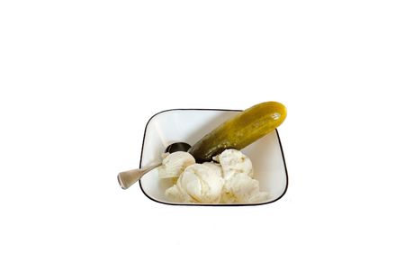 Single pickle and ice cream in a bowl with a spoon isolated on a white backgroundの写真素材
