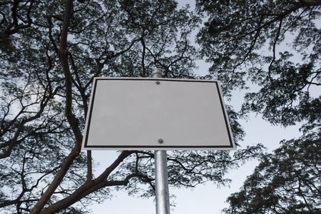 blank sign with copy space with tree branches aboveの写真素材