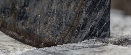 an ax blade on a wooden chopping blockの写真素材