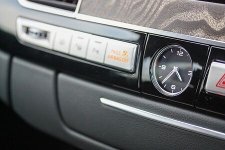 Close up of analog clock on luxury car dashboard