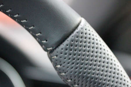Macro of a luxury performance vehicle steering wheelの写真素材