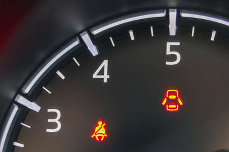 Close-up of vehicle tachometer with warning lightsの写真素材