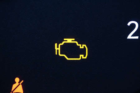 Yellow check engine lamp illuminatedの写真素材