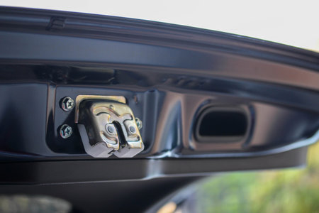 Close-up of a tailgate lock and handle on a modern vehicleの写真素材