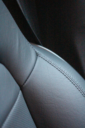 Closeup of a black leather seat in a modern car interior.の写真素材