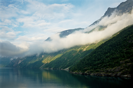 Ferry ride through Geiranger Fjord in Norway on a sunny dayの写真素材
