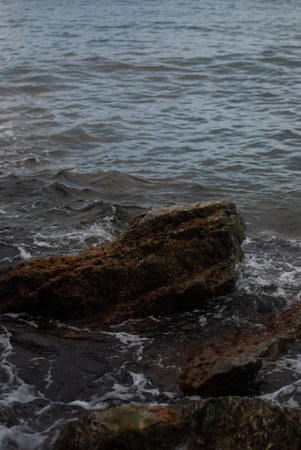 View of stones with foam and wavesの写真素材