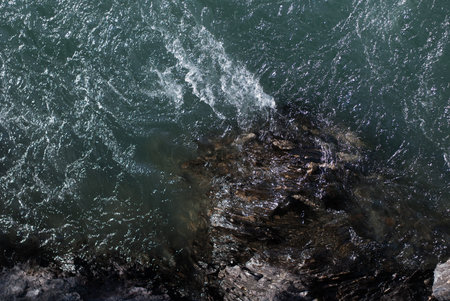 View on river with clear water near rock