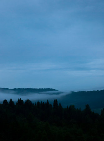 Misty mountain landscape with foggy forest in the foreground, Slovakiaの写真素材