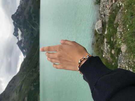 Hiking in the Swiss Alps with a view of a mountain lake