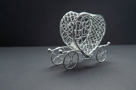 The carriage, the wagon. On a black background white metal beautiful. The best