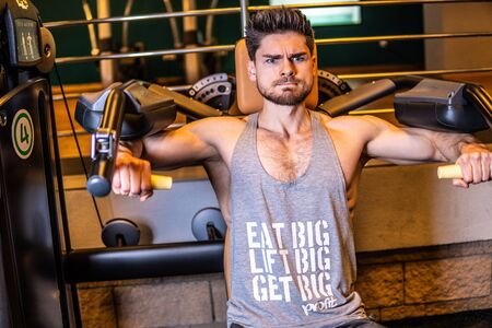 RUSSIA, MOSCOW - November 22, 2019. Fitness clubBeautiful structure, inflated body, muscles man with glasses, bodybuilder athlete bicepsのeditorial素材