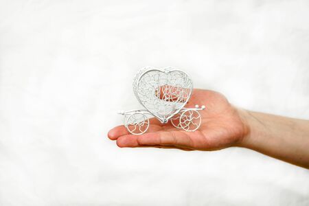 Hand in the palm of a carriage of white wire, on a white backgroundの写真素材