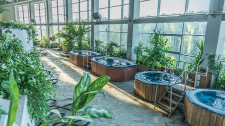 Hot tub small pool brown sun loungers Standing water calm in water water waiting for people. RUSSIA, MOSCOW - AUG 23, 2020のeditorial素材
