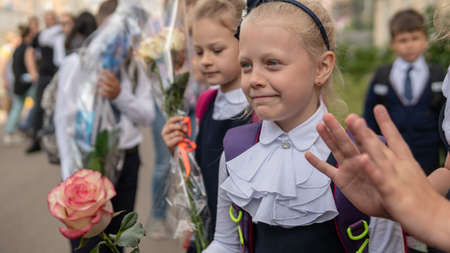 Beautiful girls go to school with flowers. RUSSIA, MOSCOW - SEP 01, 2020のeditorial素材
