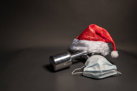 Dumbbells fitness Santa Claus on a black background with a medical mask by covid19の写真素材