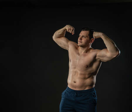 Mans biceps shows bare torso Young male business model, attractive guy bodybuilder. Men boy success...