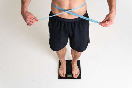 Man with weights health pondered, health and sports on a white background ache hurt muscle, cramp sick isolated massage medicine, expression. Hold red therapy, disease suffer attractiveの写真素材