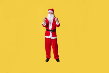 Santa claus yellow fat tradition background december people. Grandpas eve time middle fingerの写真素材