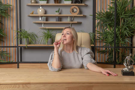 A pen in the teeth, and in the mouth business gir work, In the afternoon indoor phone for businesswoman lifestyle smile, casual glasses. Smartphone search nerd, night executiveの写真素材