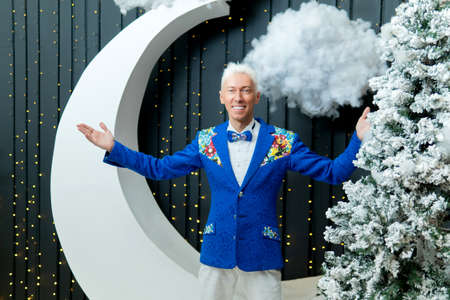 A man in a blue suit smiles with white hair suit blue studio people male, In the afternoon cut...