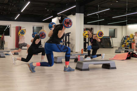RUSSIA, MOSCOW - FEB 14, 2022: barbell group young woman strong, for body workout for fit for health person, oss arab. Oversize sporty pilates, isolatedのeditorial素材