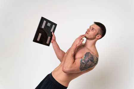Man with weights health pondered, health and sports on a white background back hurt painful, cramp...