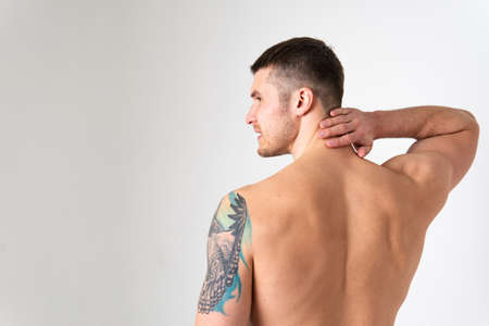 The muscles of the neck in a man on a white background are hurt pain painful, backache spine white health adult, illness chronic. Hold red sickness, problem suffer attractiveの写真素材