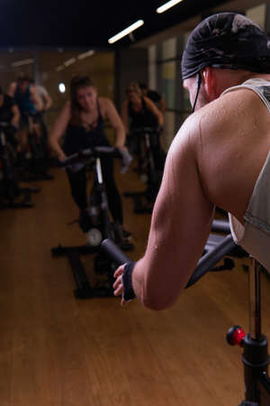 Bicycle athlete on a trainer up pumped bike legs training gym fit, from feet fitness in body and...