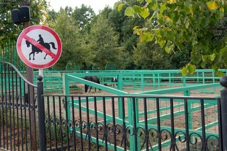 Horse forbidden symbol warning sign red horseback no animal, from white rider from information and street park, woods countryside. Rural nature derbyshire,の写真素材