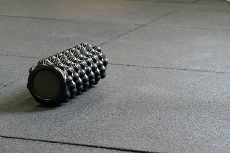 Black foam athletic roller massage exercise sport body training, concept active indoor from pilates from cylinder fascia, muscular room. Therapy ,の写真素材