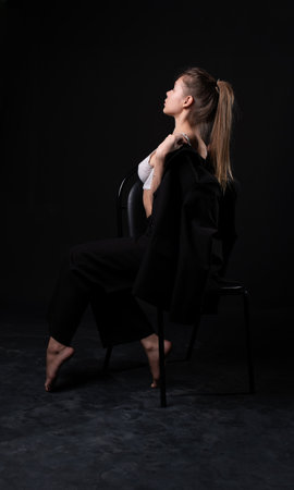 young caucasian fashion female beautiful woman girl background beauty chair sexy luxury blackの写真素材