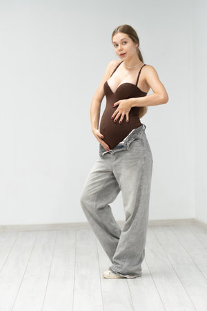 female maternity motherhood tummy happy expectant girl mother jeans pregnancy background positiveの写真素材