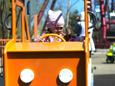 Photo of a child playing in the playground on a sunny summer or autumn dayの写真素材