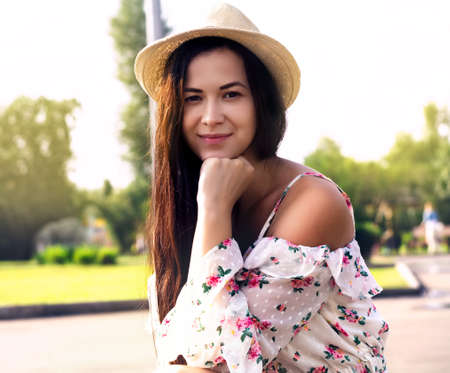 The photo shows a young girl wearing a hat on a summer sunny dayの写真素材