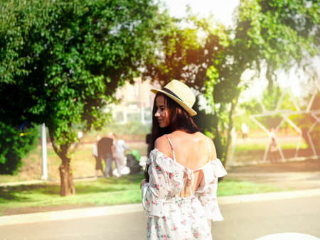 The photo shows a young girl wearing a hat on a summer sunny dayの写真素材