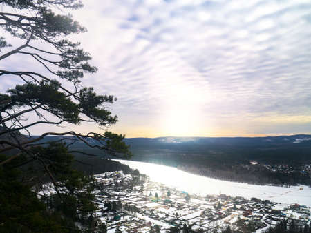 Winter landscape from mountain to river, mountains, forest and village in Siberia.の写真素材