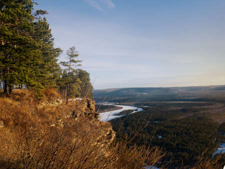 Winter landscape from mountain to river, mountains, forest and village in Siberia.の写真素材
