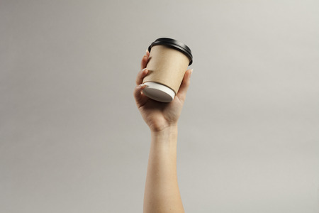 Creative mock up image of woman hand holding craft men hand holding craft cupの写真素材