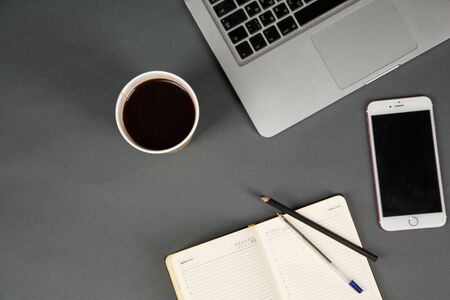 Office workplace table with supplies, smartphone and laptop. Flat lay. Top view with space for your textのeditorial素材