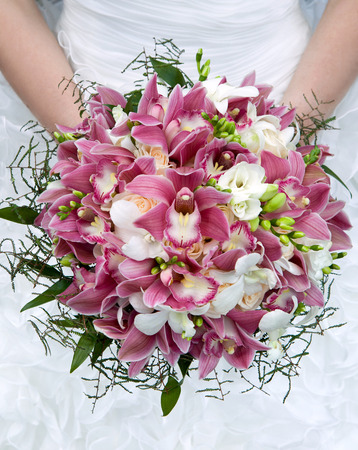 Wedding bouquet  Bouquet of fresh flowers for the wedding ceremony  Bouquet of orchids, roses and other flowers in the bride s hands closeup  Bridal bouquet の写真素材