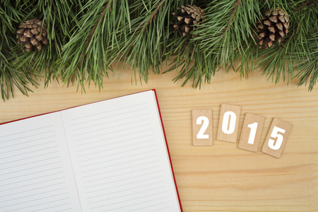 New Year background. Notebook on table with Christmas fir tree and wooden tablets with text \\\\\\\"2015\\\\\\\"の写真素材