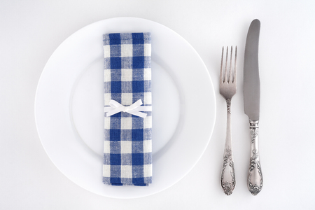 Table setting with fork, knife and blue checkered napkinの写真素材
