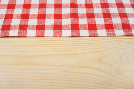 Red and white tablecloth on white wooden table. Selective focus, copy spaceの写真素材