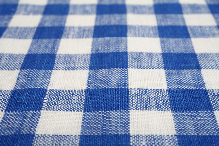 Blue and white checkered fabric as a background texture with selected focusの写真素材