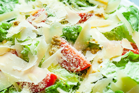 Close-up of a vegetarian salad made from different types of lettuce, cheeses and cherry tomatoes, dressed with olive oil and mustardの写真素材