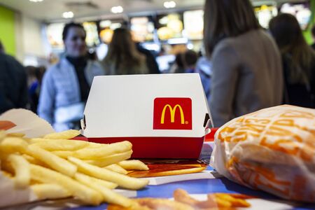 Minsk, Belarus, April 14, 2018: Big Mac Box with McDonald's logo, cheeseburger and french fries on a...