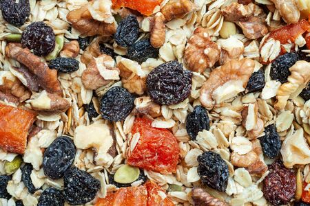 Organic homemade Granola with oats, nuts and dried fruits. Texture oatmeal granola or muesli as...
